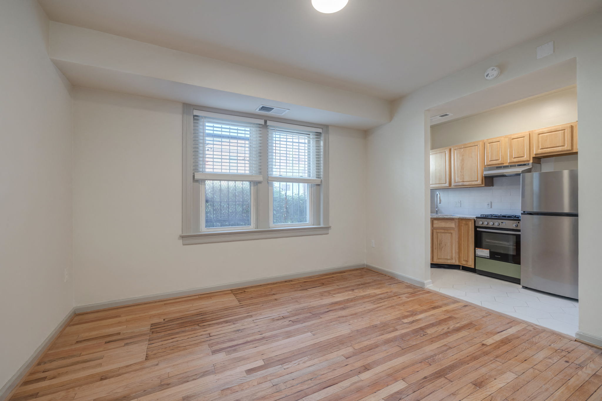A kitchen with wooden floors and stainless steel appliances.